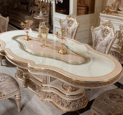 Decorative dining table with ornate chairs in a luxurious room.