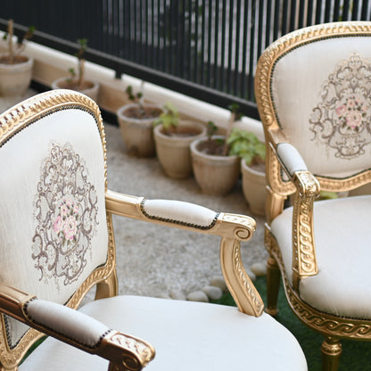 Decorative chairs with intricate patterns in a garden setting