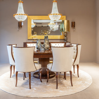 Dining room with a round wooden table, white chairs, and decorative vases.