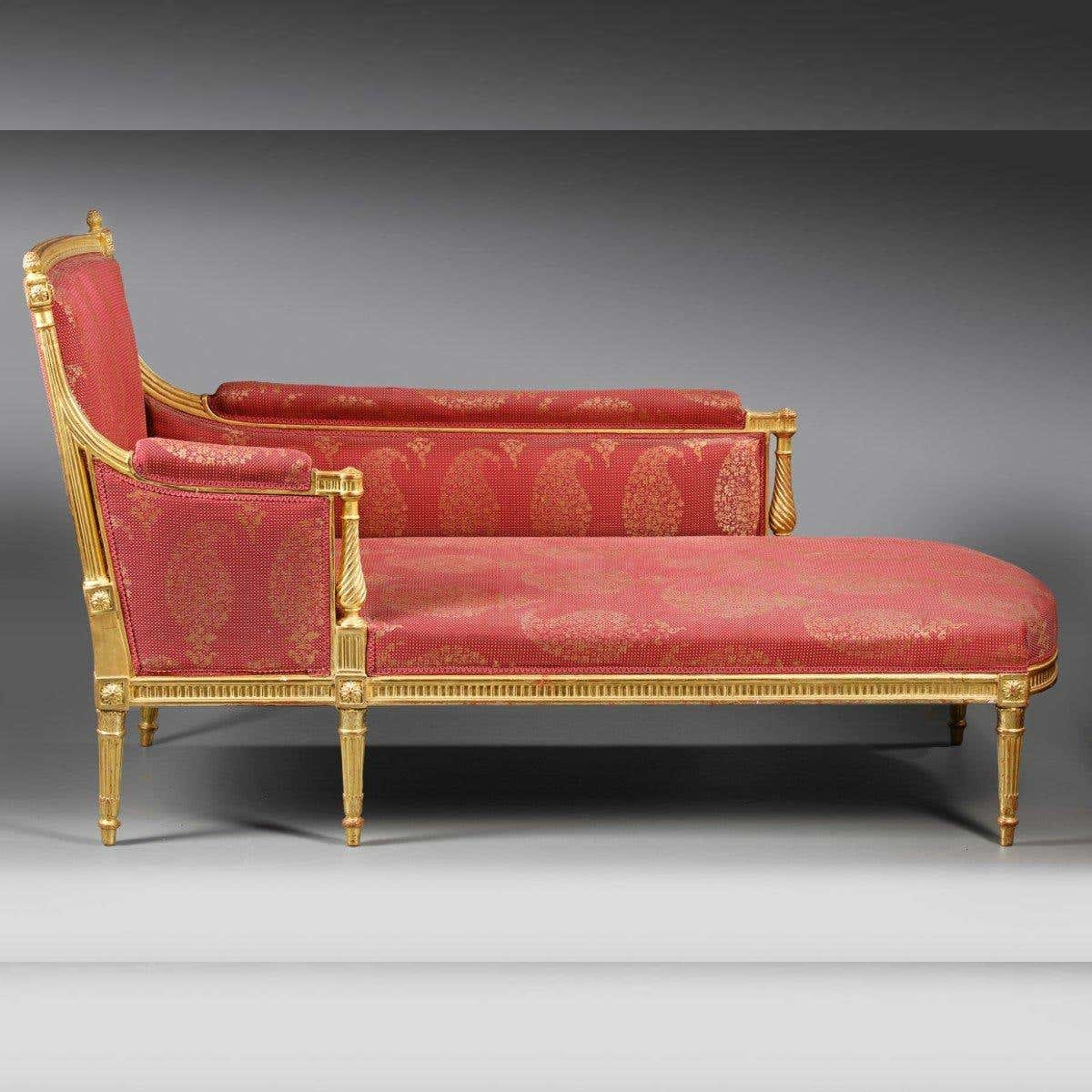 Red upholstered sofa with gold frame on a gray background