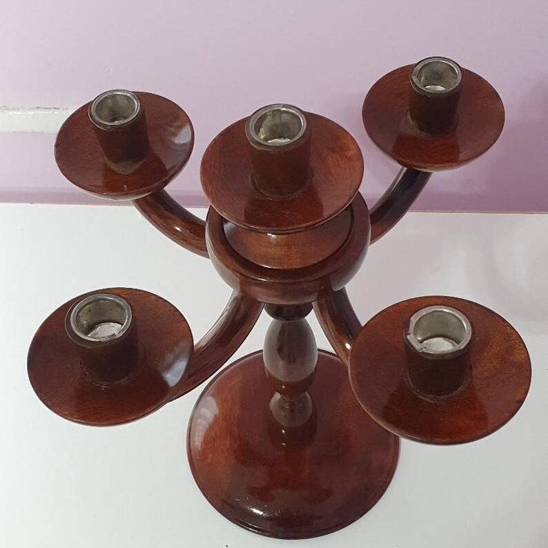 Wooden candelabrum with five candle holders on a white background