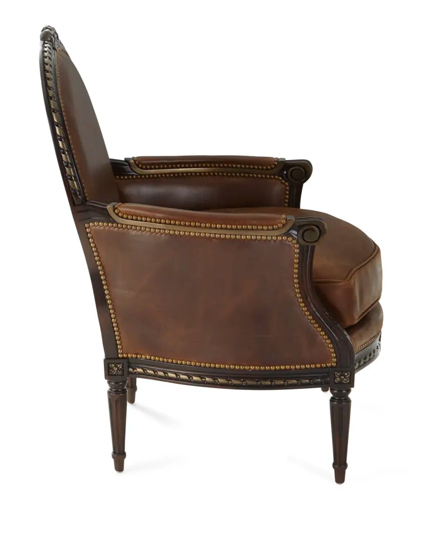 Brown leather armchair with nailhead trim on a white background