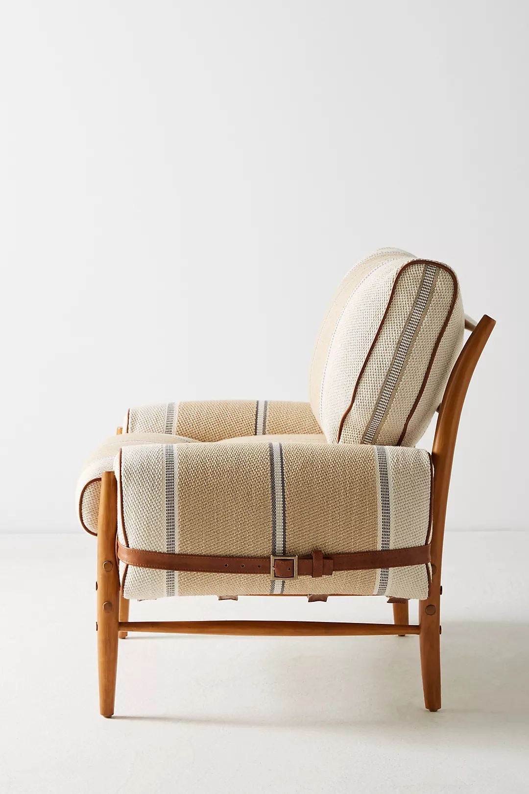 Wooden chair with striped blanket and brown strap on a white background