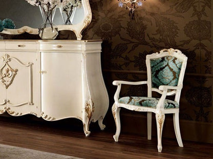 Decorative sideboard with ornate design in a room with patterned wallpaper.