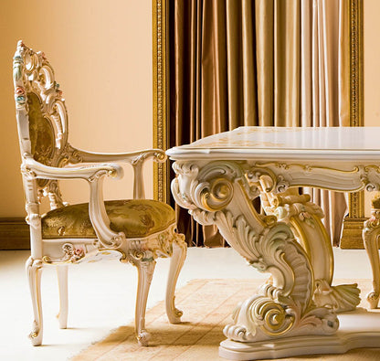 Decorative dining table and chair with intricate designs in a room with beige walls and curtains.