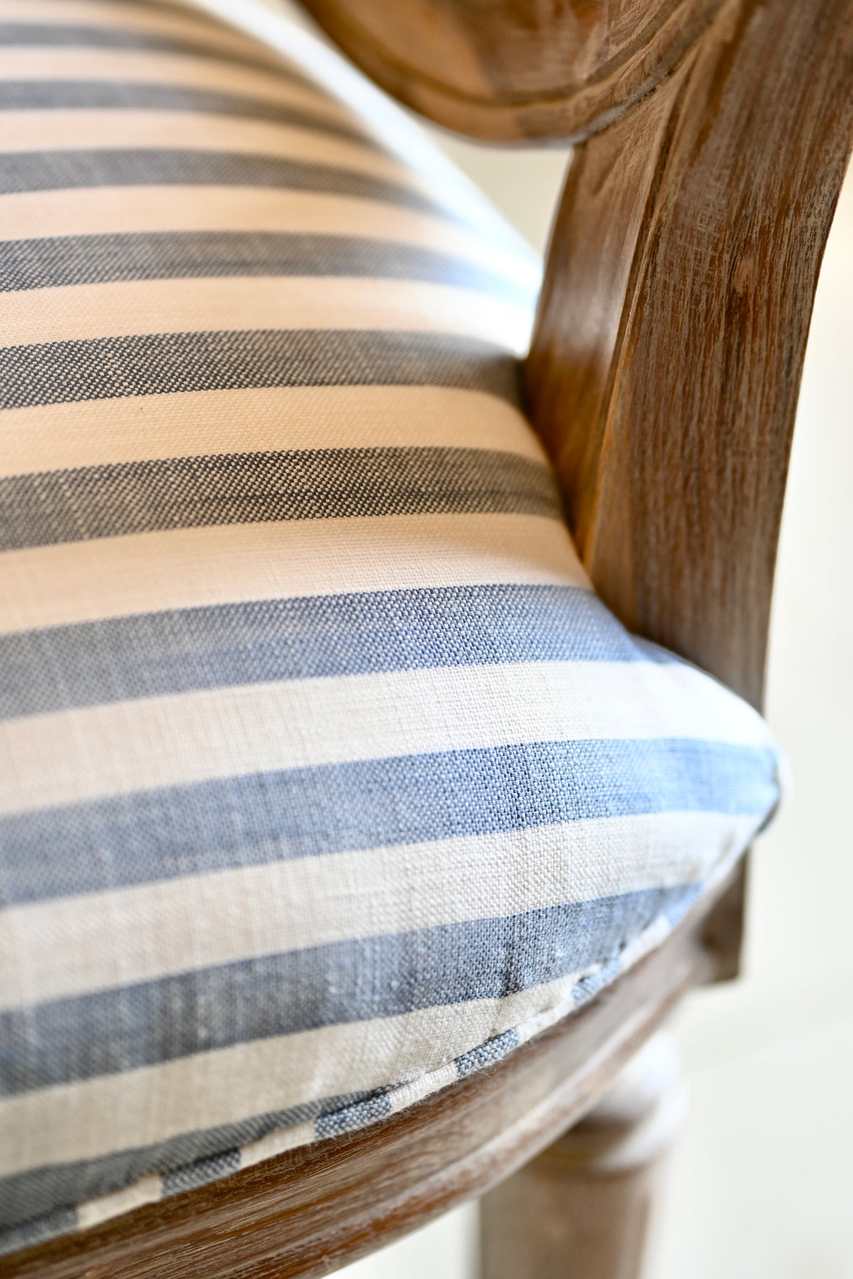 Striped cushion on a wooden chair