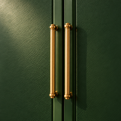 Two vertical brushed gold metal cabinet handles mounted on dark green textured doors.