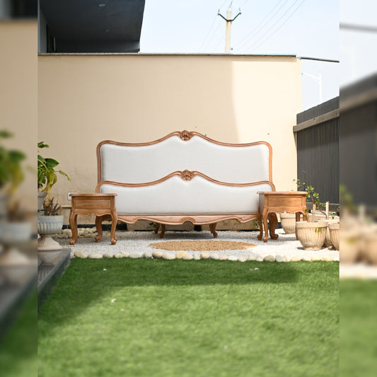 White sofa with wooden frame on a grassy area
