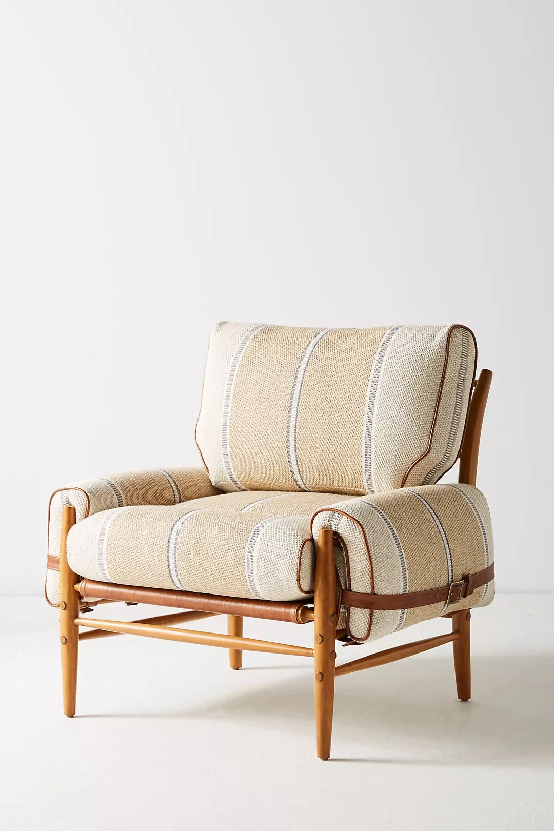 Beige armchair with striped pattern on a white background