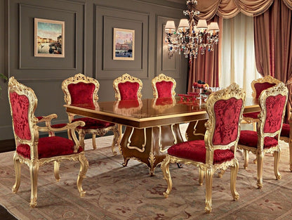 Dining room with a gold table and red chairs in a luxurious setting.