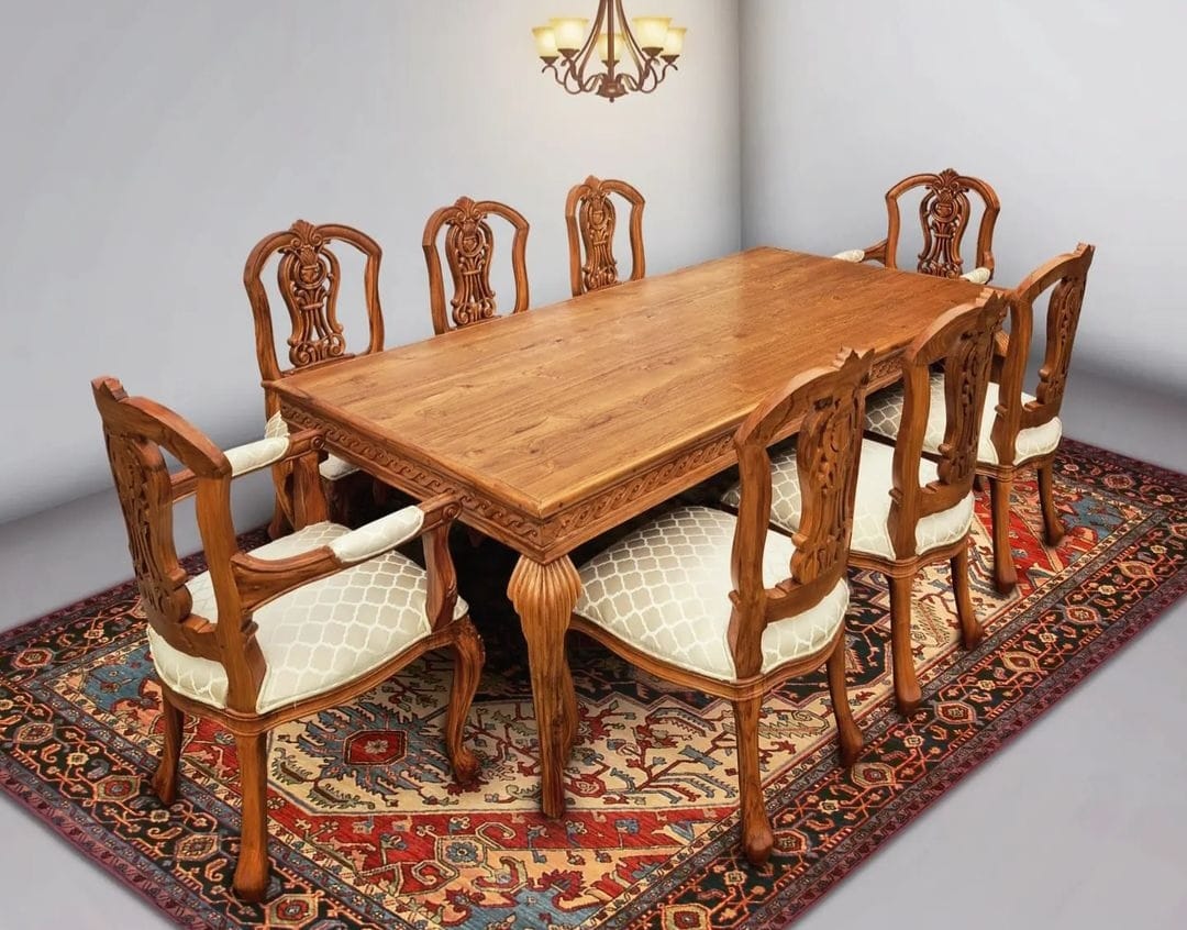 An 8-seater dining set with a natural wood finish and upholstered chairs with a floral pattern on a patterned rug.