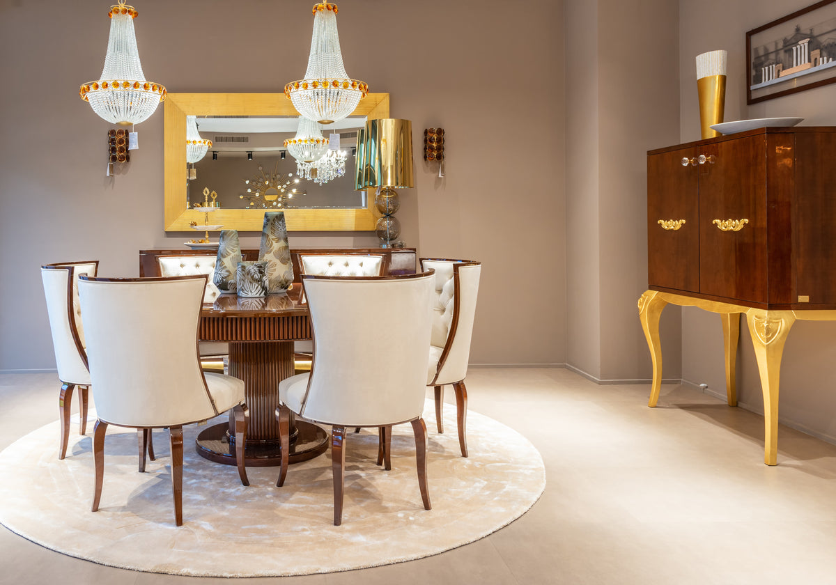 Dining room with wooden table, chairs, and a sideboard.