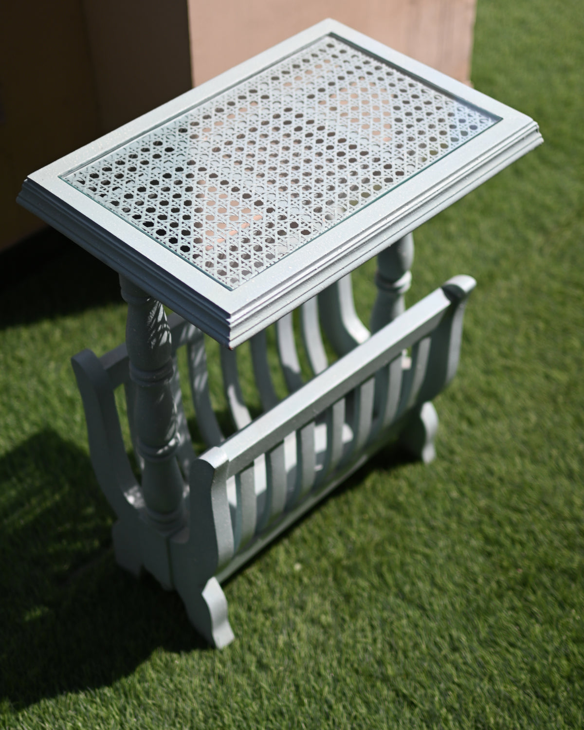 Small decorative table with a lattice top on a grassy surface