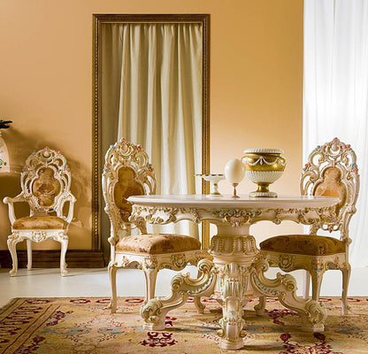 Decorative table and chairs in a room with a large mirror and yellow walls.