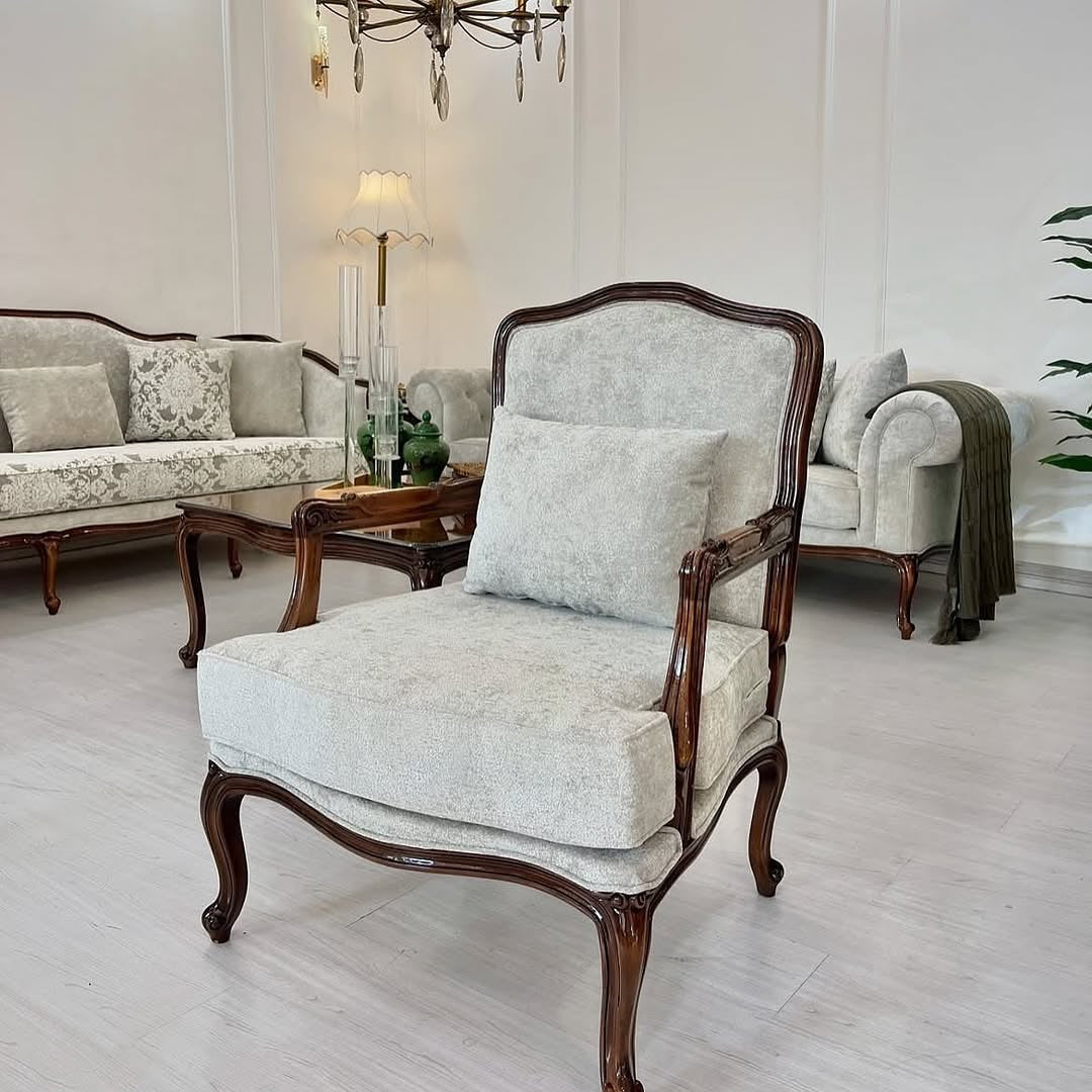 Elegant living room with a vintage-style armchair and matching sofa.