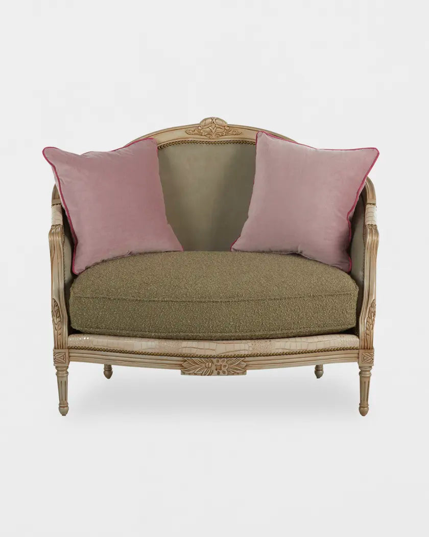 Vintage-style loveseat with green cushion and pink pillows on a white background