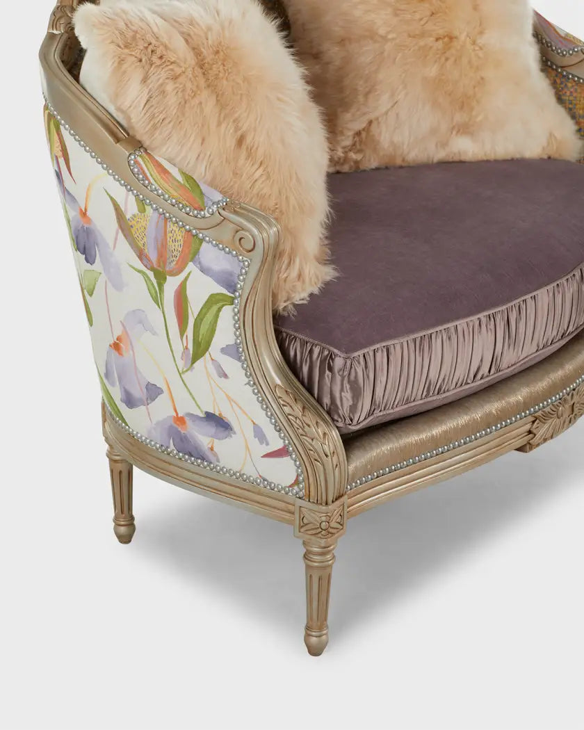 Decorative armchair with floral patterned backrest and fur cushion on a white background