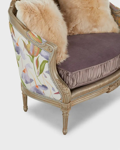 Decorative armchair with floral patterned backrest and fur cushion on a white background