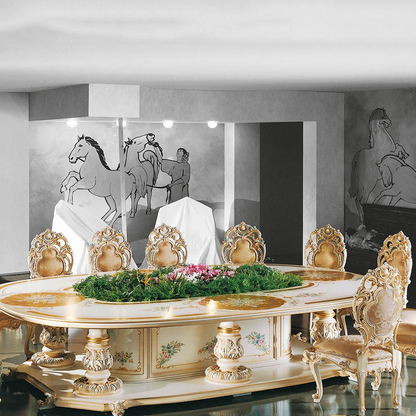 Decorative dining table with ornate chairs in a room with horse paintings on the wall.