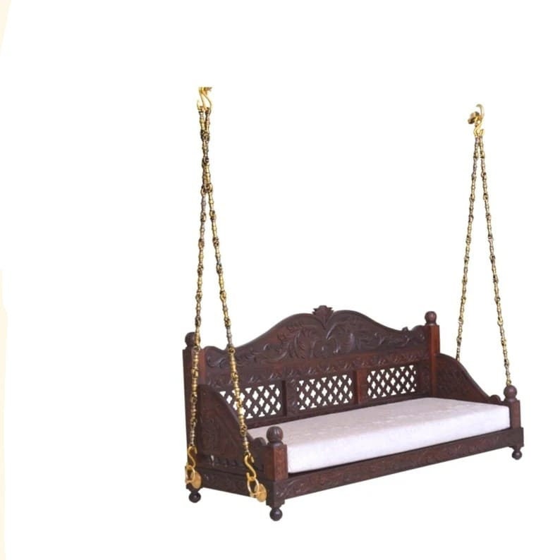 A handcrafted mahogany wood swing with antique finish, beige cushion, and golden steel hangers.