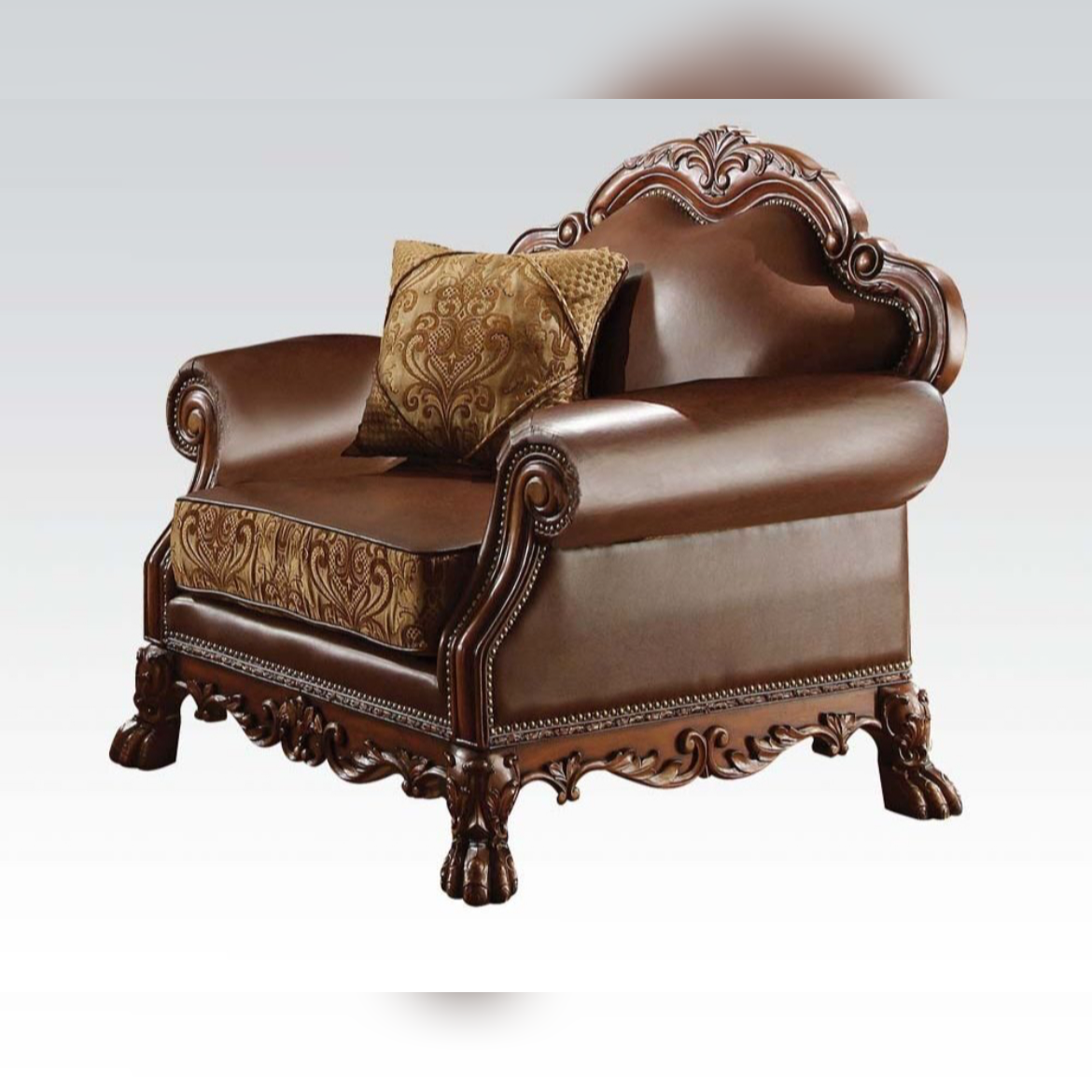 Decorative brown armchair with intricate carvings and a patterned pillow on a white background