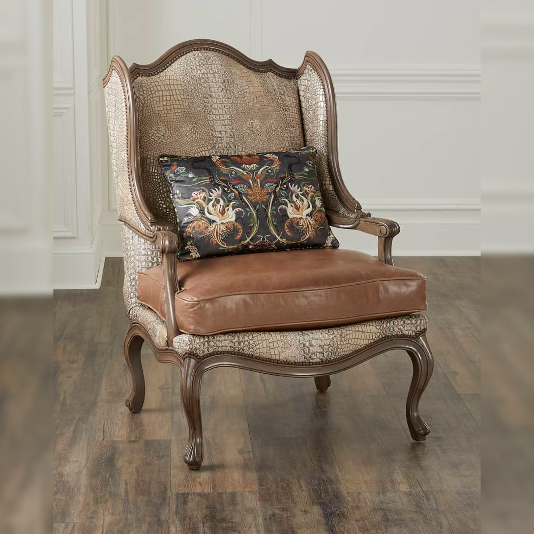 Decorative armchair with patterned backrest and brown cushion on a wooden floor.