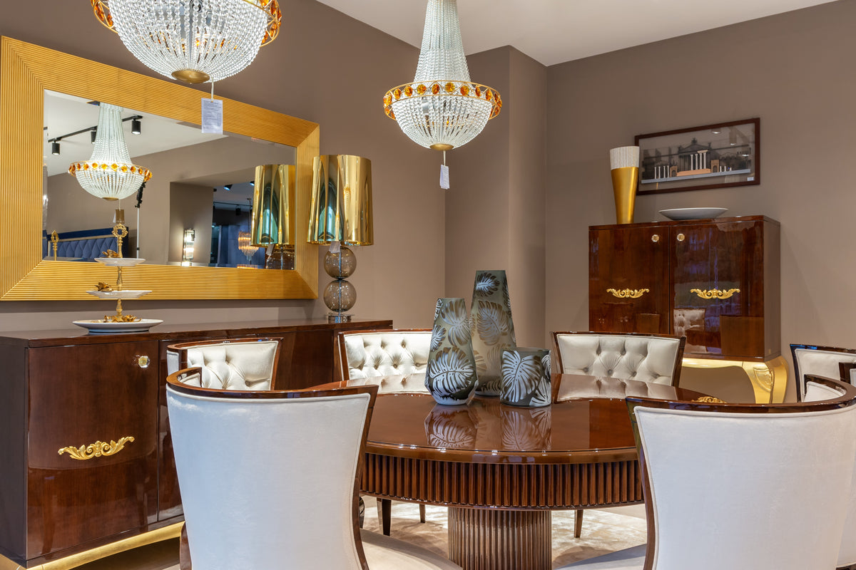 Dining room with wooden furniture, chandeliers, and decorative items.
