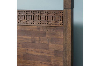 Wooden headboard with decorative carvings on a light blue background