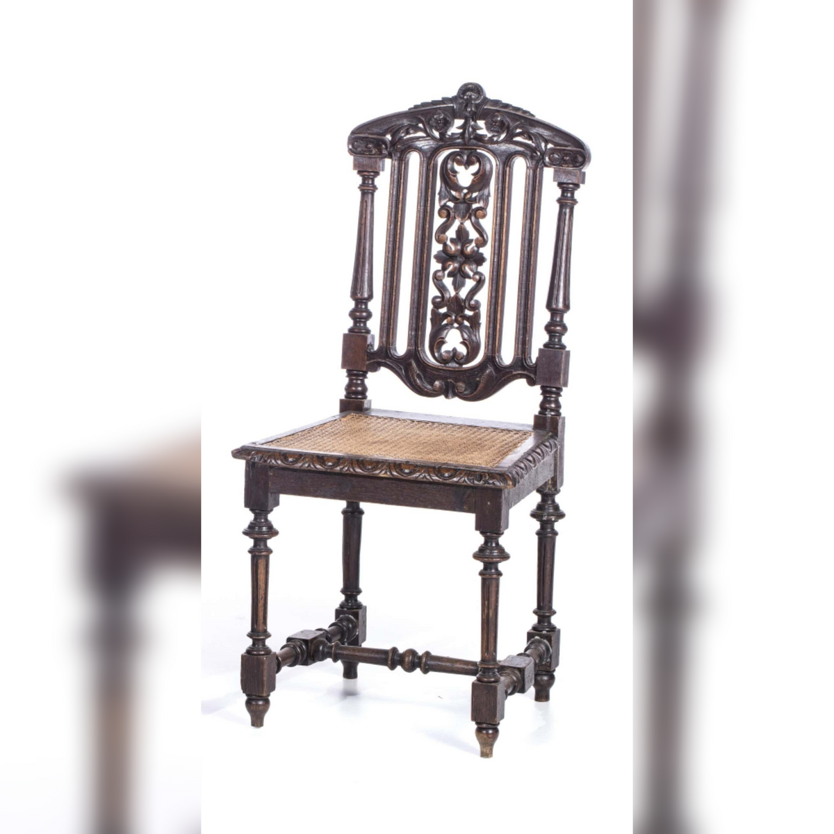 Decorative wooden chair with intricate carvings on a white background