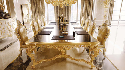 Luxurious dining room with gold table and chairs in a well-lit room.
