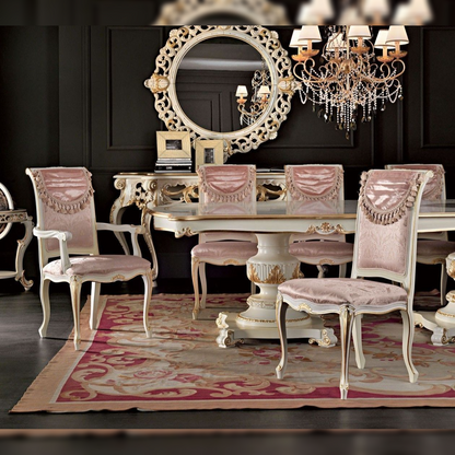 Dining room with ornate table, chairs, and chandelier in a dark room.