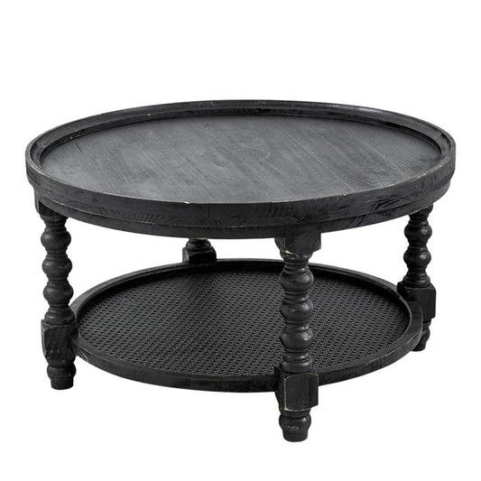 A round black teak double-decker coffee table with a lower shelf featuring intricate bamboo work, supported by carved antique feet.